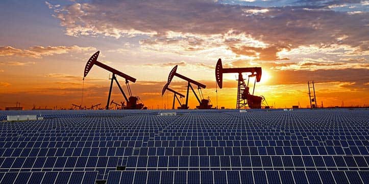 Field of solar panels with oil pumpjacks