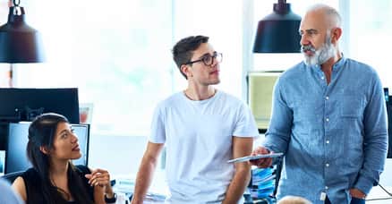 Several professionals discussing ideas in a collaborative office environment